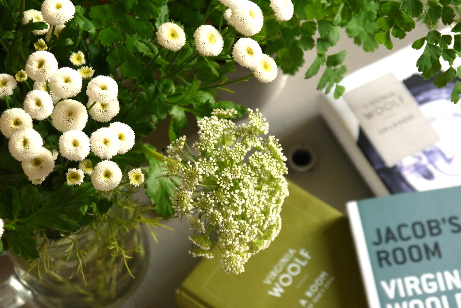 Flowers with several editions of Virginia Woolf's works