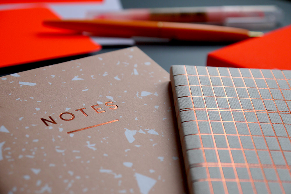 A selection of Orange Stationery - small notebooks
